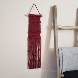 Red wall hanging with barrel knots